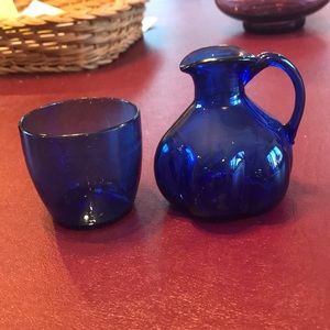 Blue depression glass pitcher with cup